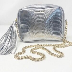 Victoria’s Secret silver snake skin purse with gold chain strap.